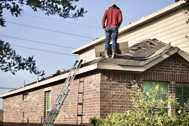Professional roofer working on a residential roof in Monmouth